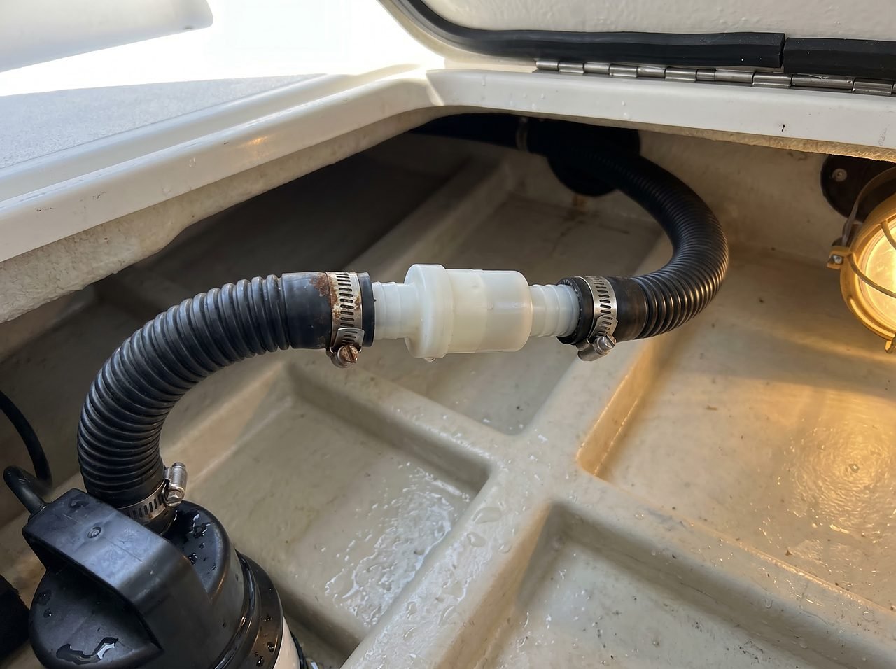 inline check valve installed on bilge pump discharge hose to prevent siphon-back