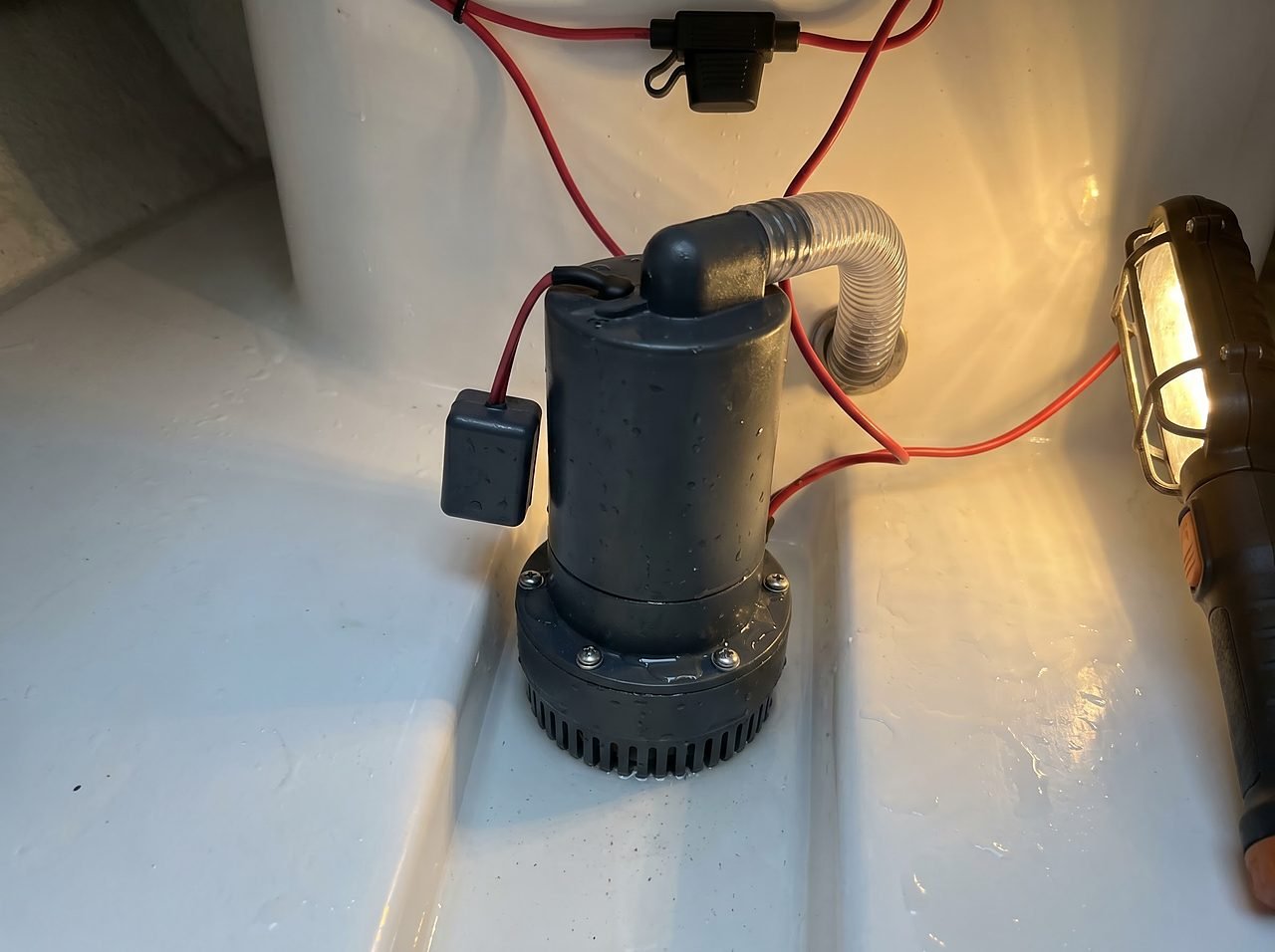 automatic bilge pump with float switch installed in the lowest point of a boat bilge