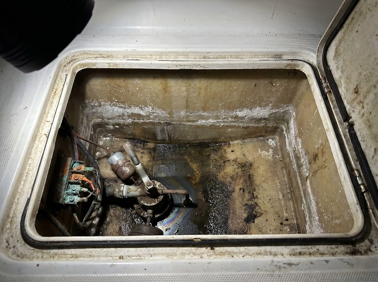 open boat bilge showing oily residue and mineral staining during a pre-purchase inspection