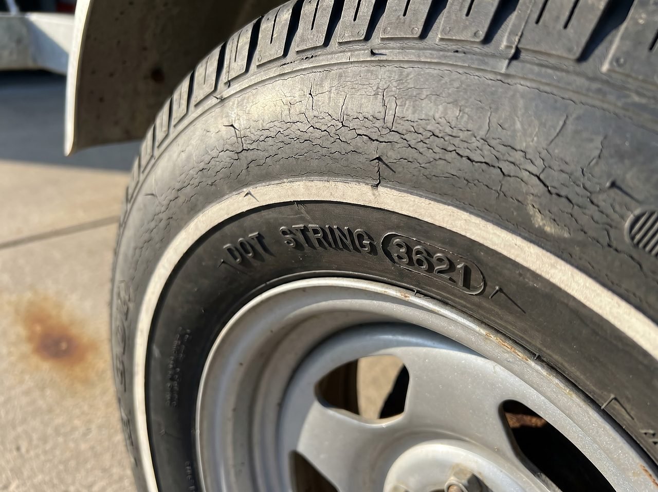 trailer tire sidewall showing UV cracking and DOT date code despite good tread depth remaining