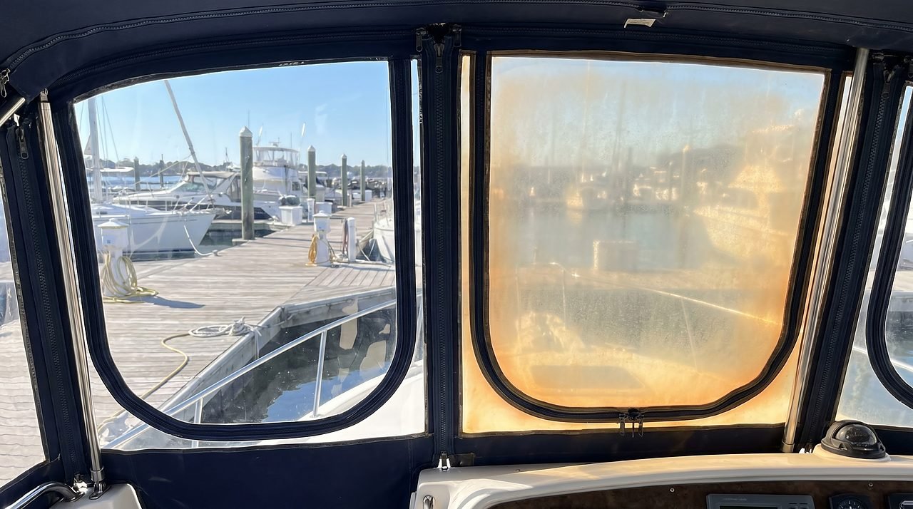 two clear vinyl boat window panels showing the difference between a maintained and a UV-yellowed panel