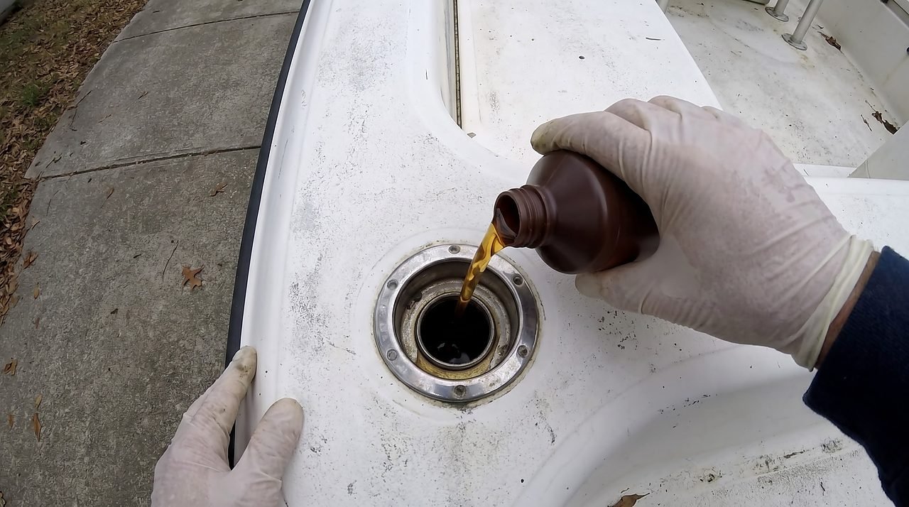 adding fuel stabilizer to a boat fuel tank before winter storage