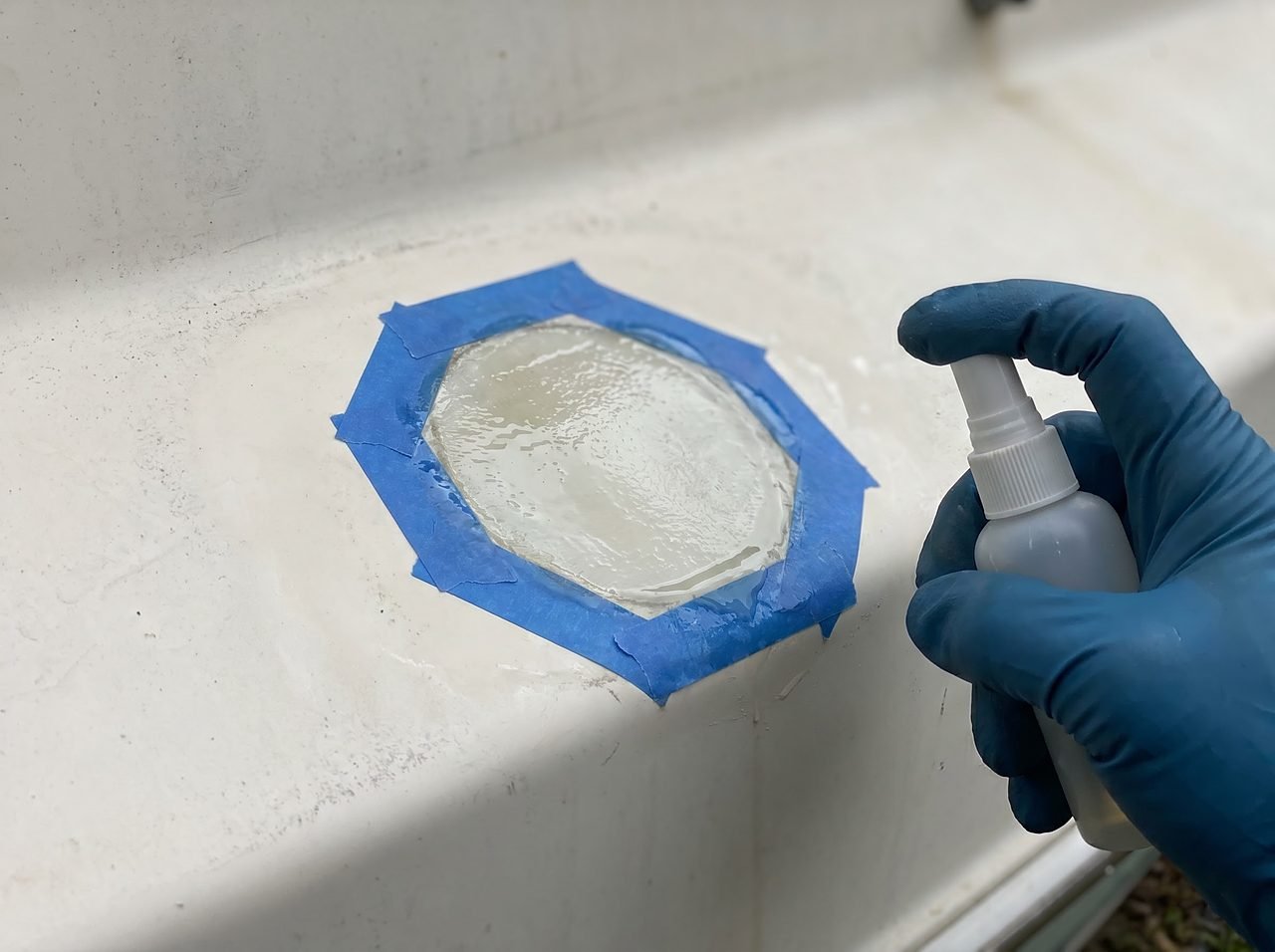PVA release film sprayed over a freshly applied gelcoat repair patch on a white hull