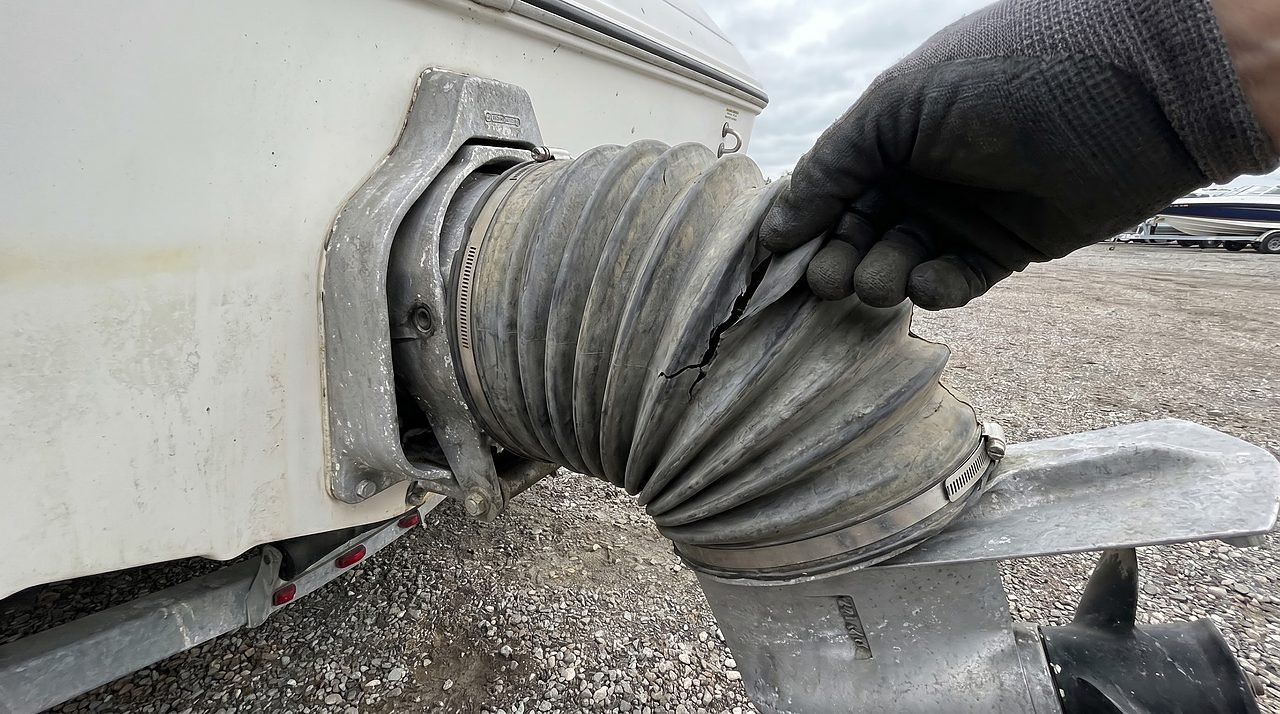 inspecting a sterndrive bellows for cracks during boat winterization