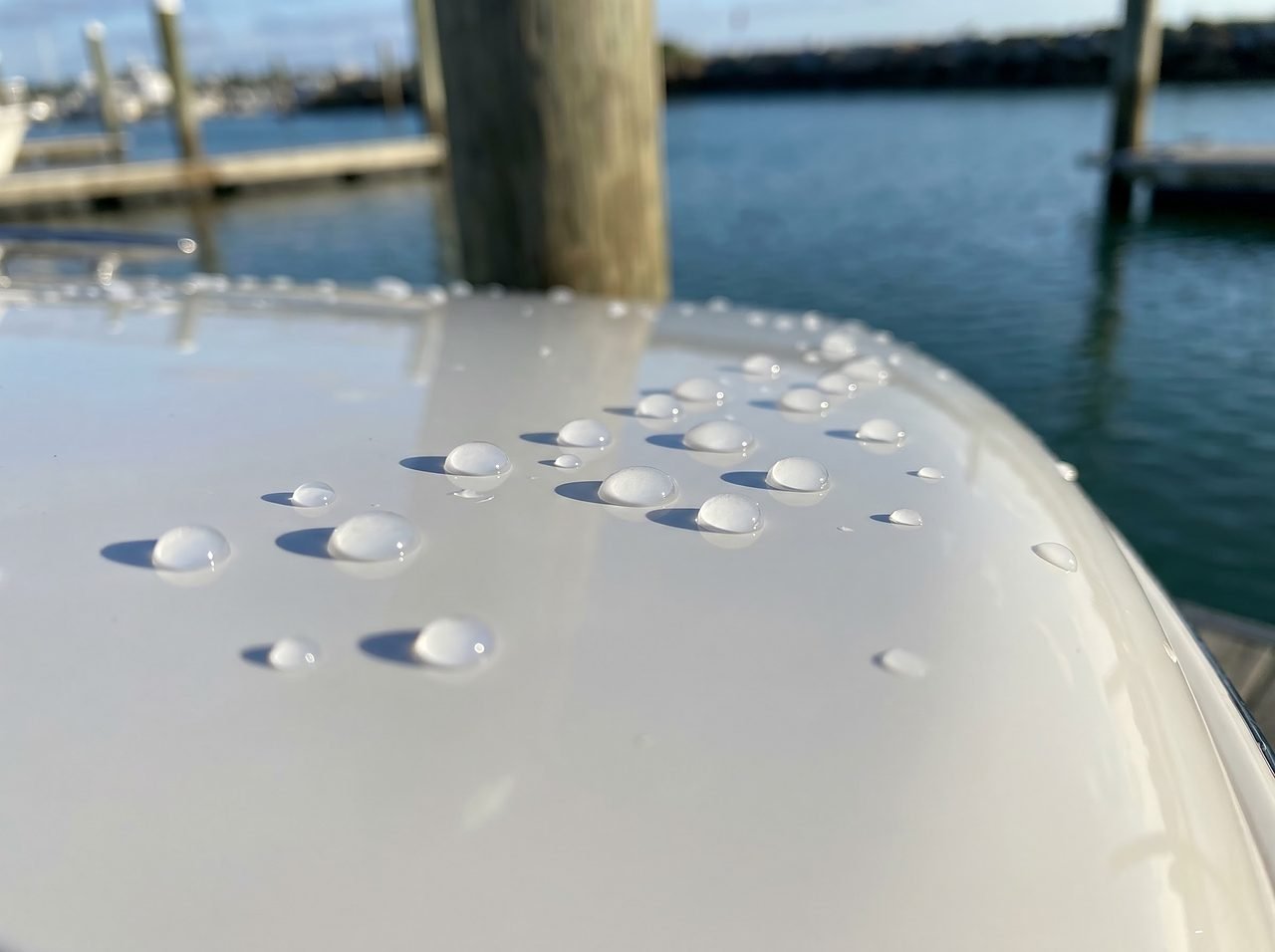tight spherical water beads on a ceramic-coated fiberglass boat hull showing hydrophobic effect