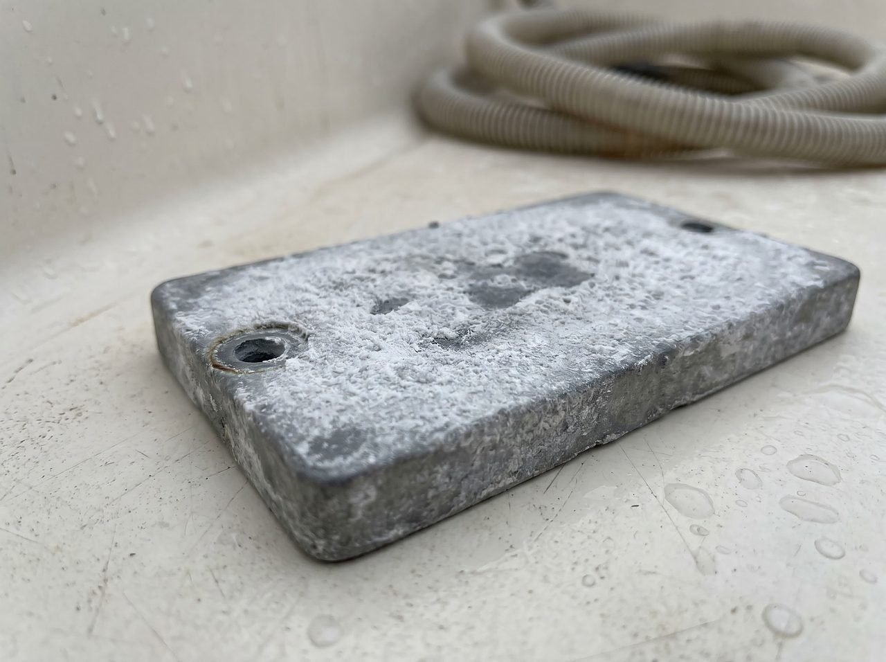 Close-up of a passivated zinc anode with chalky white film after a freshwater season